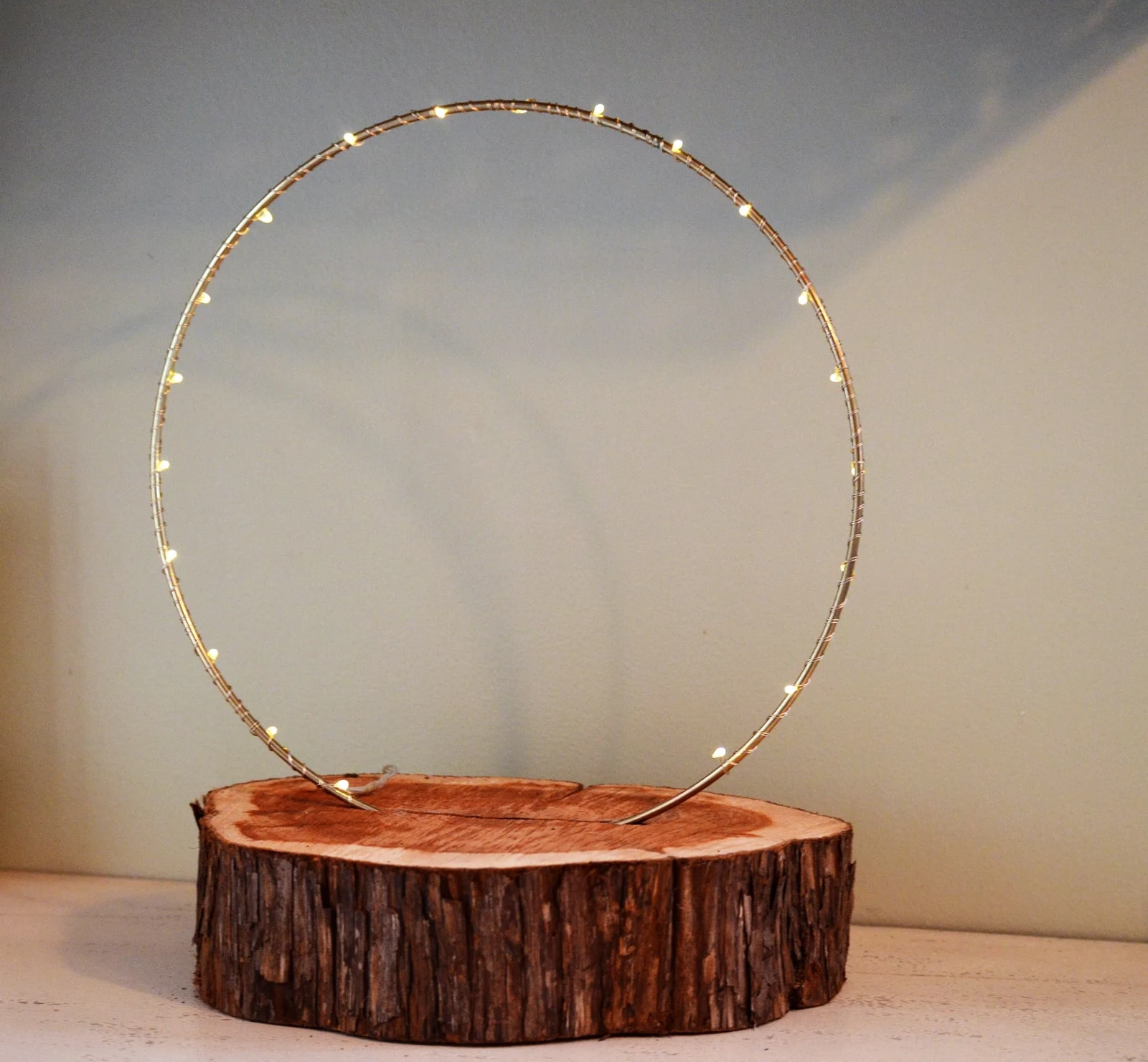 wood slab with lit golden hoop.jpg